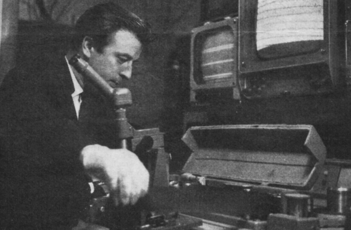 A man in gloves handles tape on spools